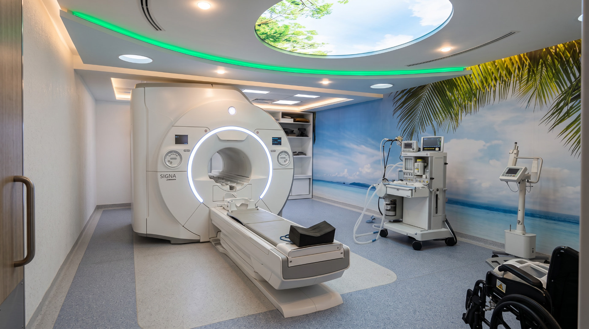 A completed MRI suite with a scenic beach mural and integrated interior design